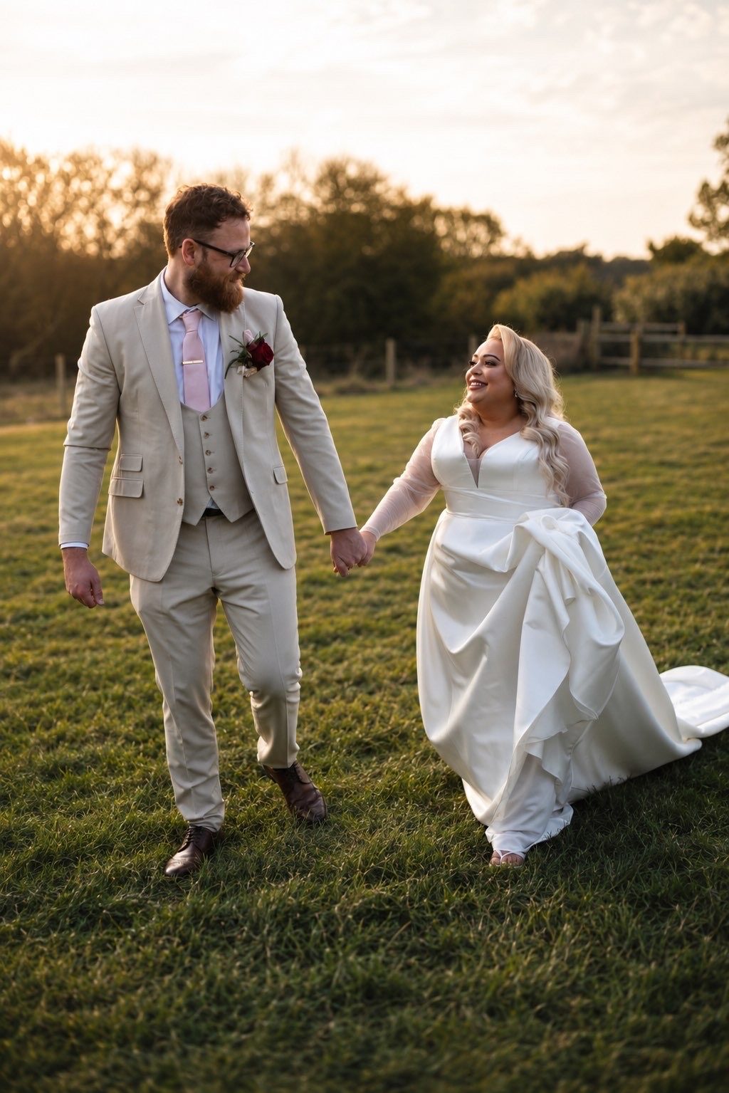 A newly married couple walking together in warm evening light