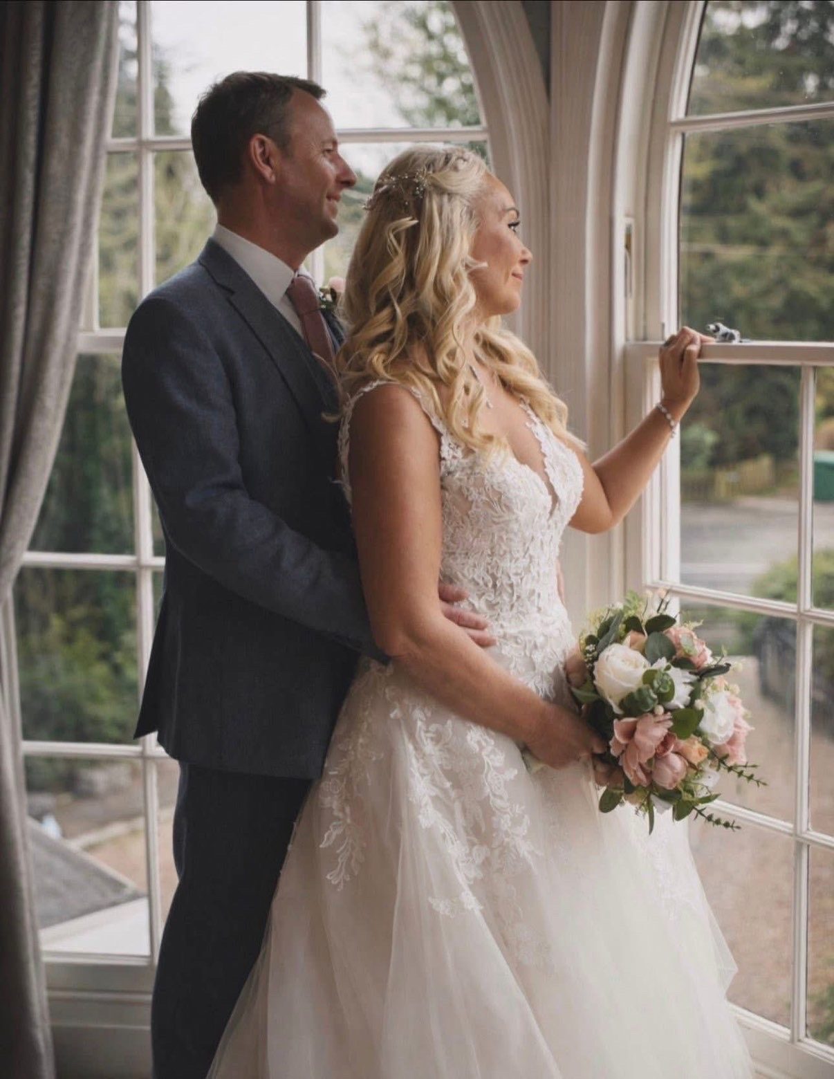Wedding couple by a bright window