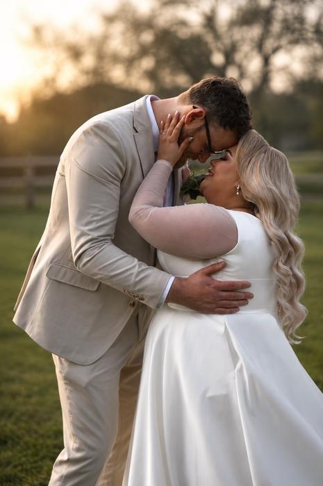 Wedding couple embracing in golden light