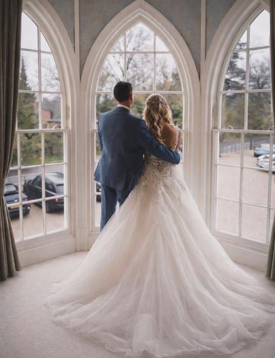 Bride and groom in a bright window setting