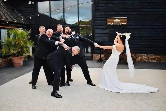 Bride and groom with wedding party outside a venue