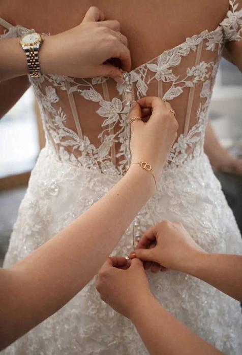 Wedding dress being fastened