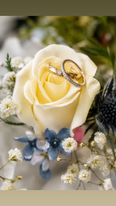 Wedding rings placed in a rose