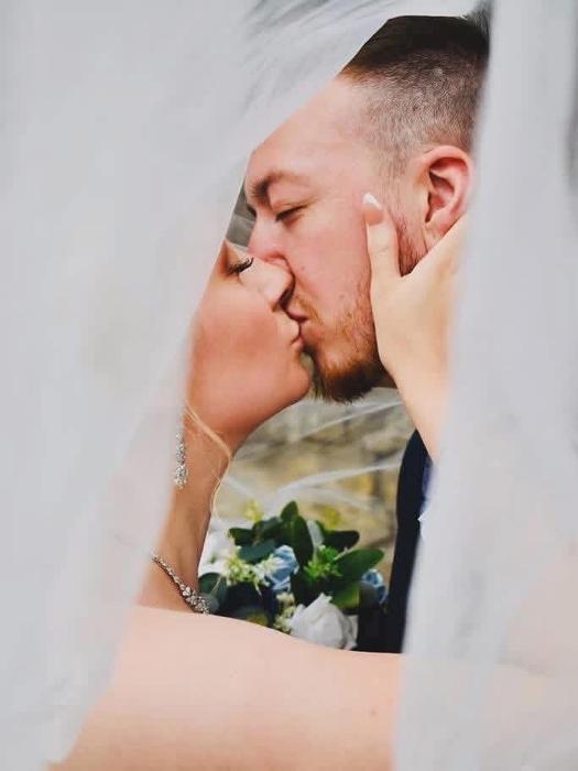 Close-up wedding couple portrait through a veil