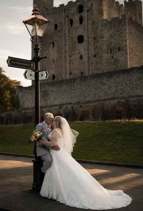 Wedding couple portrait outside stone architecture